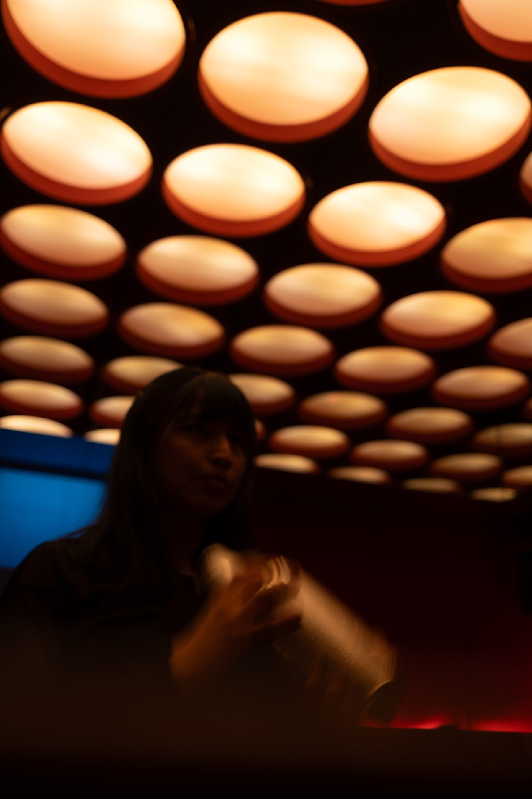 Bartender shaking a cocktail under the ceiling of lights